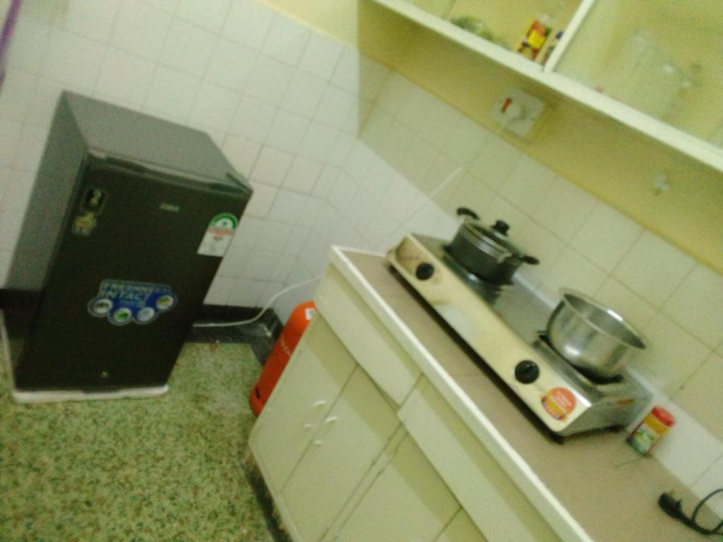 a small kitchen with a counter with a stove in it at GG homes in Nairobi