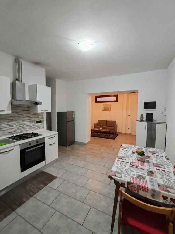 a kitchen with a table and a stove top oven at Marconi in Novi Ligure