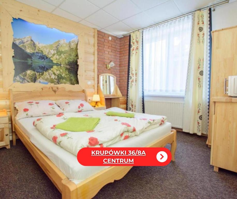 a bedroom with a large bed in a room at Krupówki 36 / 8a - Pokój 2 osobowy z widokiem na Giewont in Zakopane