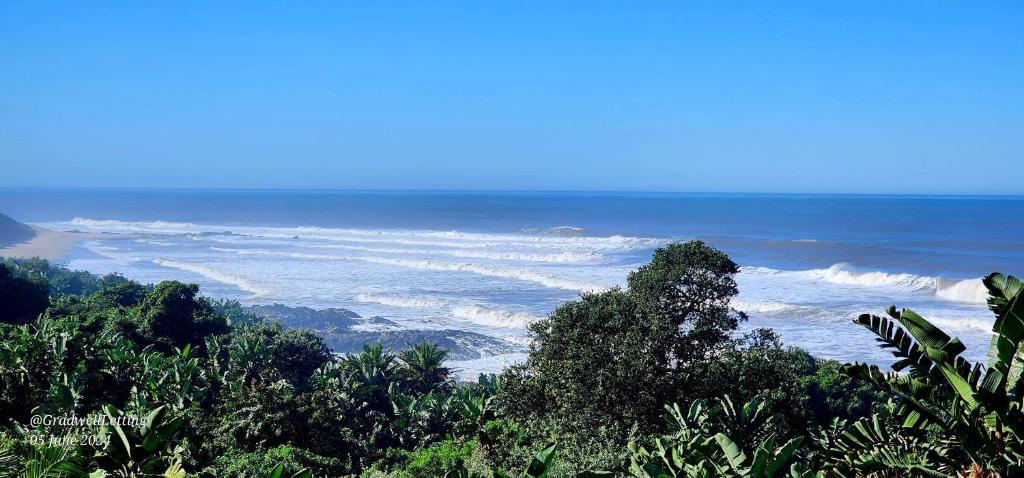 a view of the ocean from the top of a hill at Milkwood Lodge 5 - Sleeps 6 in Port Edward