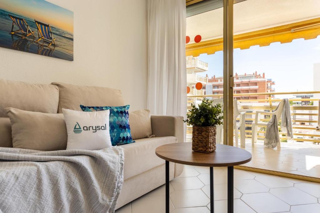 a living room with a couch and a table at NOVELTY III Arysal 3 in Salou