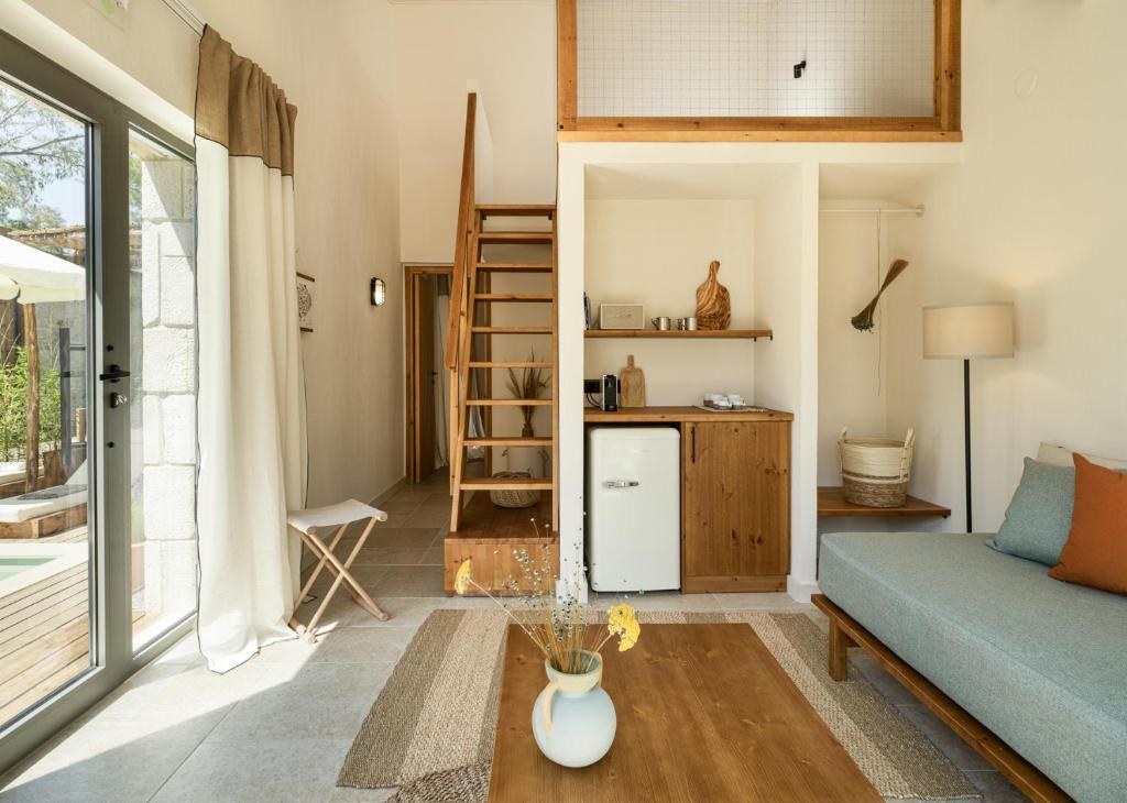 a living room with a couch and a table at Ergon Beach House Nikiti in Nikiti