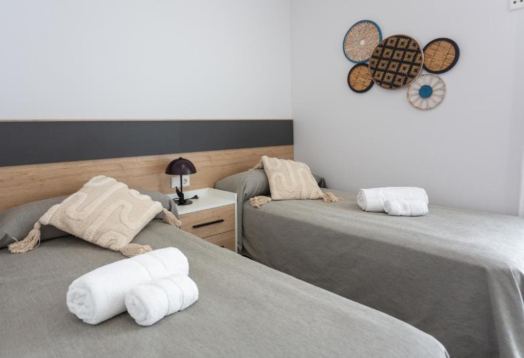 Postel nebo postele na pokoji v ubytování Oliva Suites