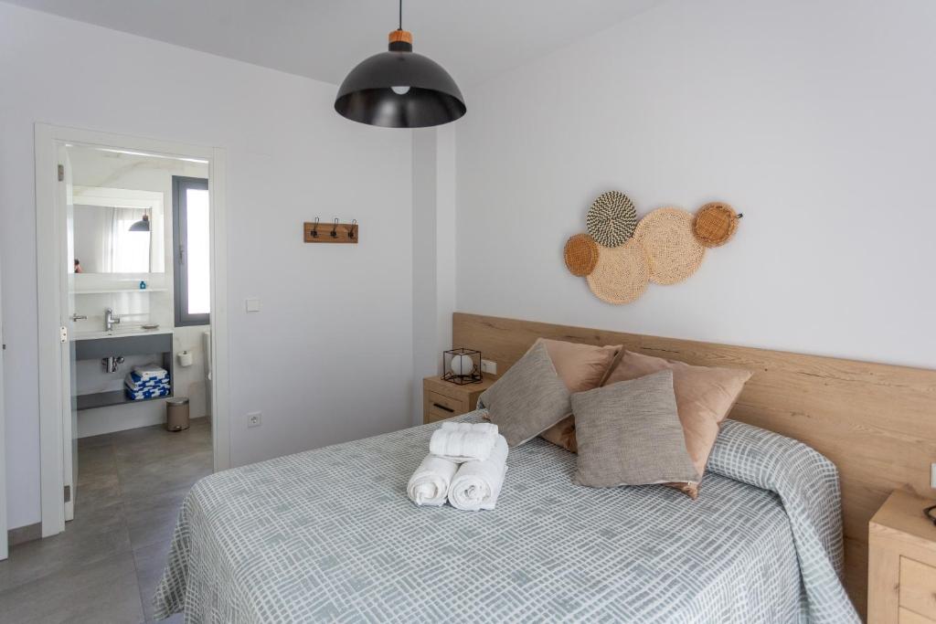 Postel nebo postele na pokoji v ubytování Oliva Suites