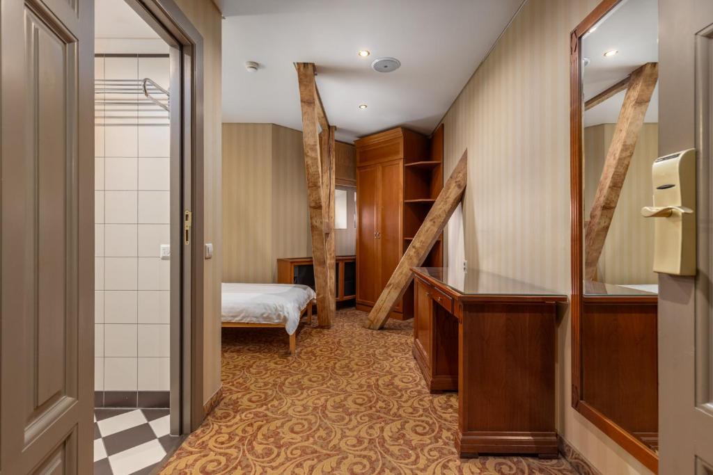 a hotel room with a bed and a bathroom at The Benjamin House in Rīga