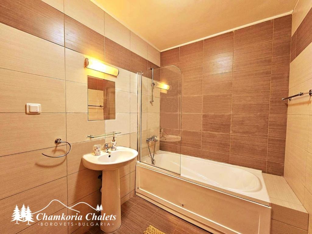 a bathroom with a sink and a shower and a tub at Chamkoria Chalets 409 in Borovets