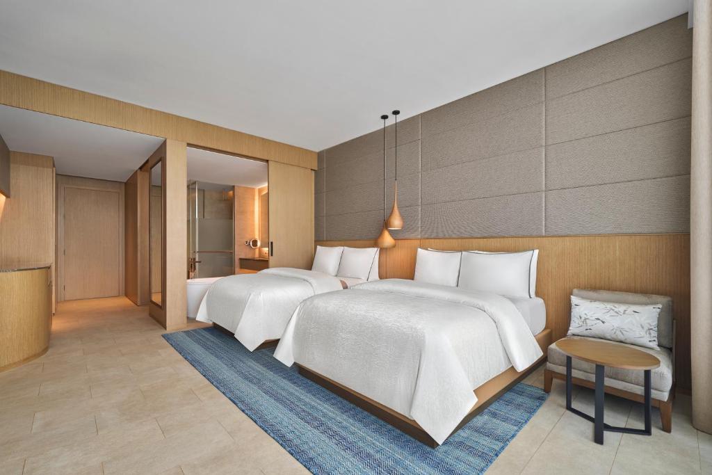 Deluxe Garden view with Two Double Beds and Balcony