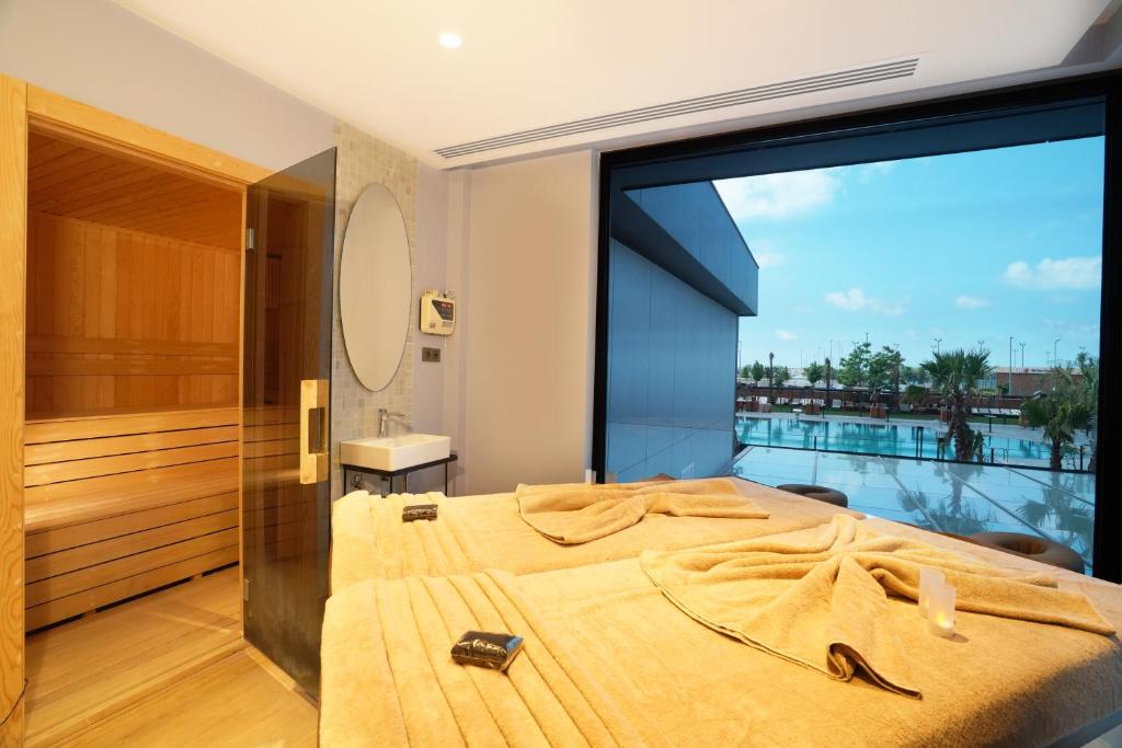 a bedroom with a bed and a large window at Sile Gonen Hotel in Şile