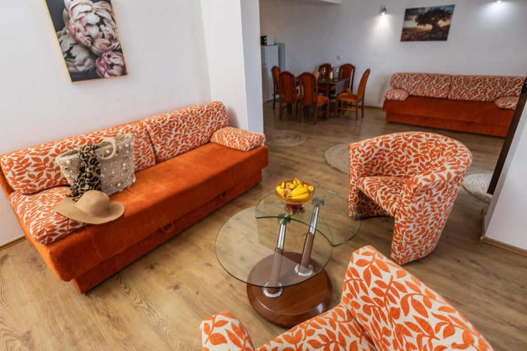 a living room with a couch and a table at Apartments Raymond in Sveti Stefan