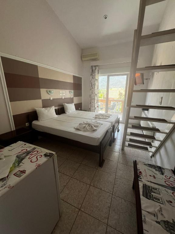 Postel nebo postele na pokoji v ubytování Ellas Hotel