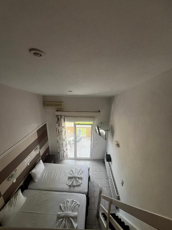 Postel nebo postele na pokoji v ubytování Ellas Hotel