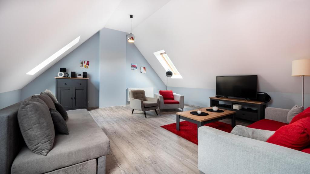 Televízia a/alebo spoločenská miestnosť v ubytovaní Apartamenty Sun & Snow Karpacz Myśliwska