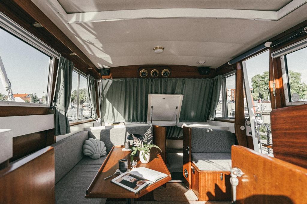 a room with a table and chairs in a van at Classic Yacht I Royal Cruiser 34 - "Barrel" in Klaipėda