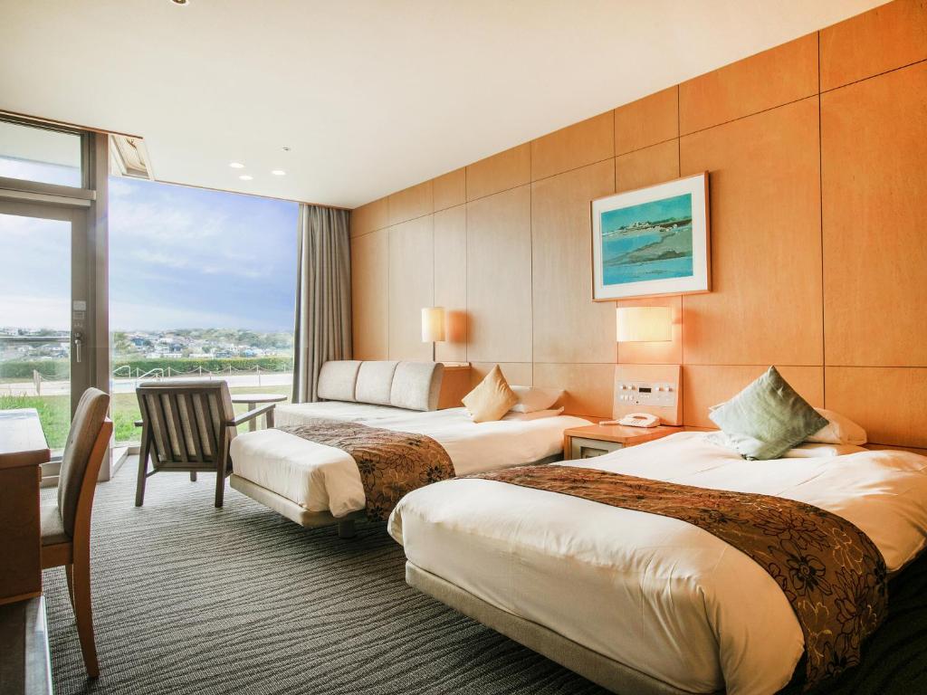 Postel nebo postele na pokoji v ubytování Kamakura Prince Hotel