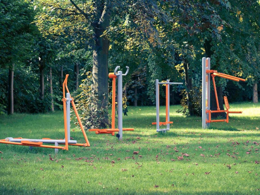a group of playground equipment in the grass at Mercure Gdańsk Posejdon in Gdańsk