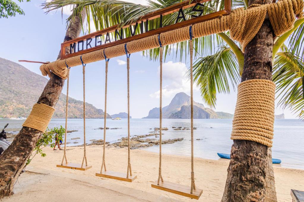 amaca su una spiaggia con palme di Morgan Villas a El Nido