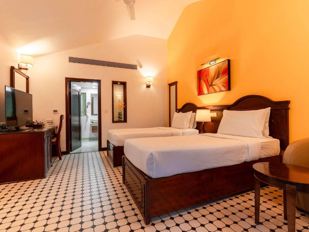 Postel nebo postele na pokoji v ubytování Novotel Goa Dona Sylvia Resort