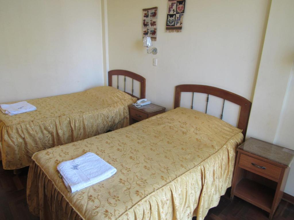 Postel nebo postele na pokoji v ubytování Hostal Siglo 21