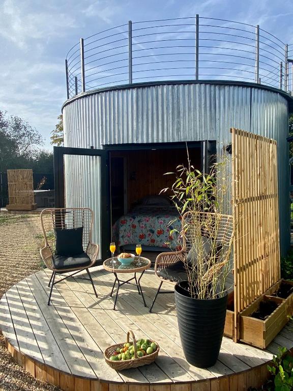a patio with a bed in a metal building at Silo Blue in Great Dunmow