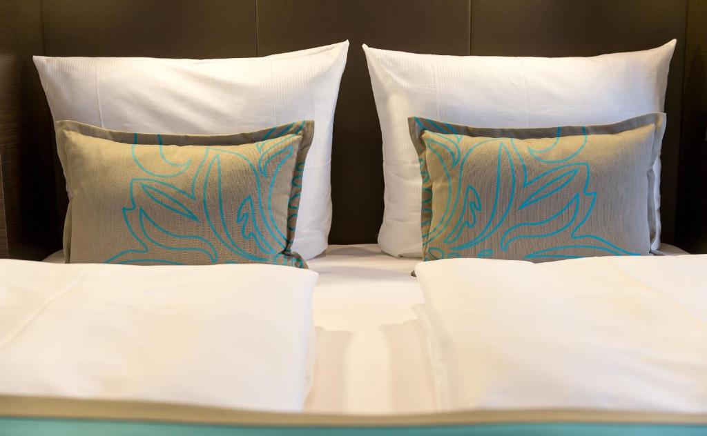 Postel nebo postele na pokoji v ubytování Motel One München-Olympia Gate