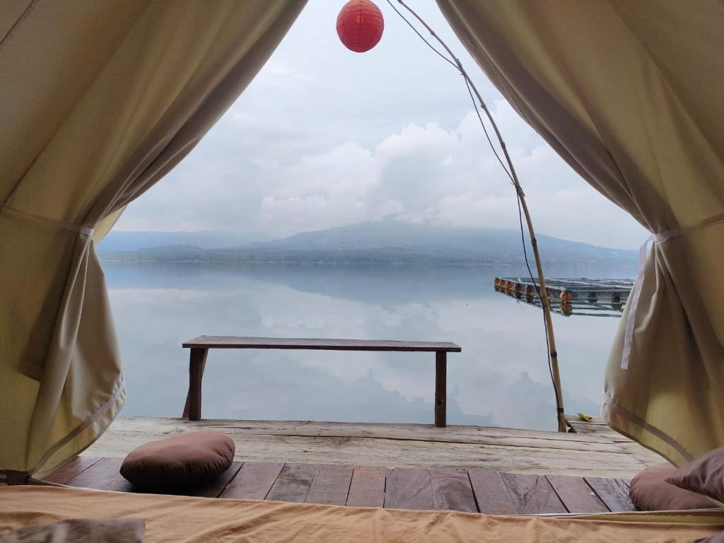 a view from the inside of a tent looking at the water at EMaYan Glamping in Kubupenlokan