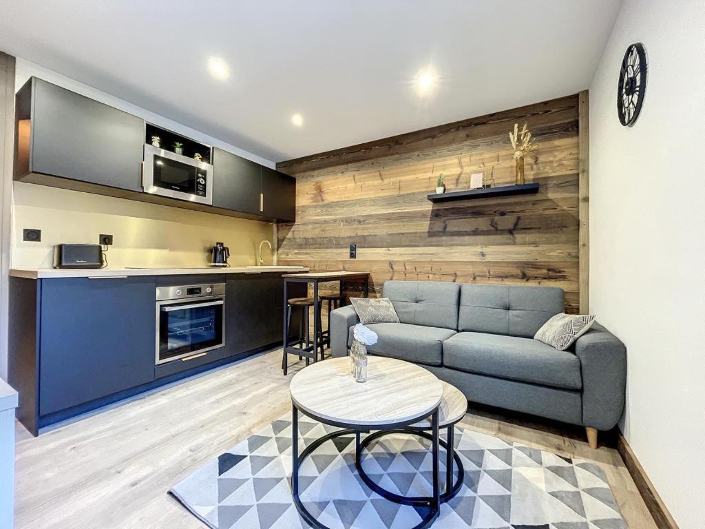 a living room with a couch and a table at Centre village station ski in Saint-Gervais-les-Bains