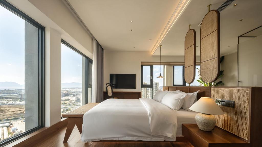 Postel nebo postele na pokoji v ubytování 昆明市呈贡区椿屿岚酒店 Chun Yulan Hotel