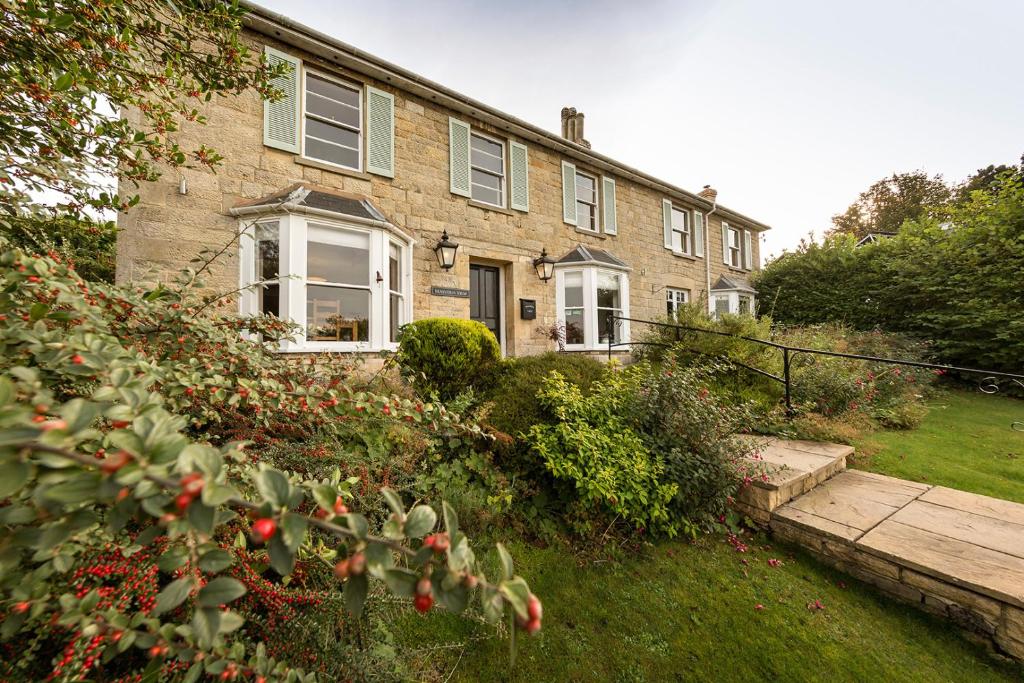 a brick house with a garden in front of it at Malvern View in Cheltenham