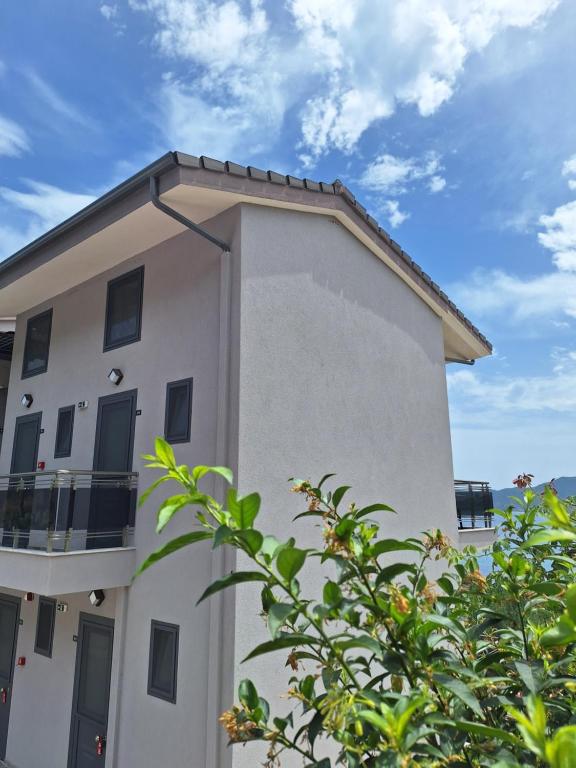 a large white building with a roof at Sarti Thea in Sarti