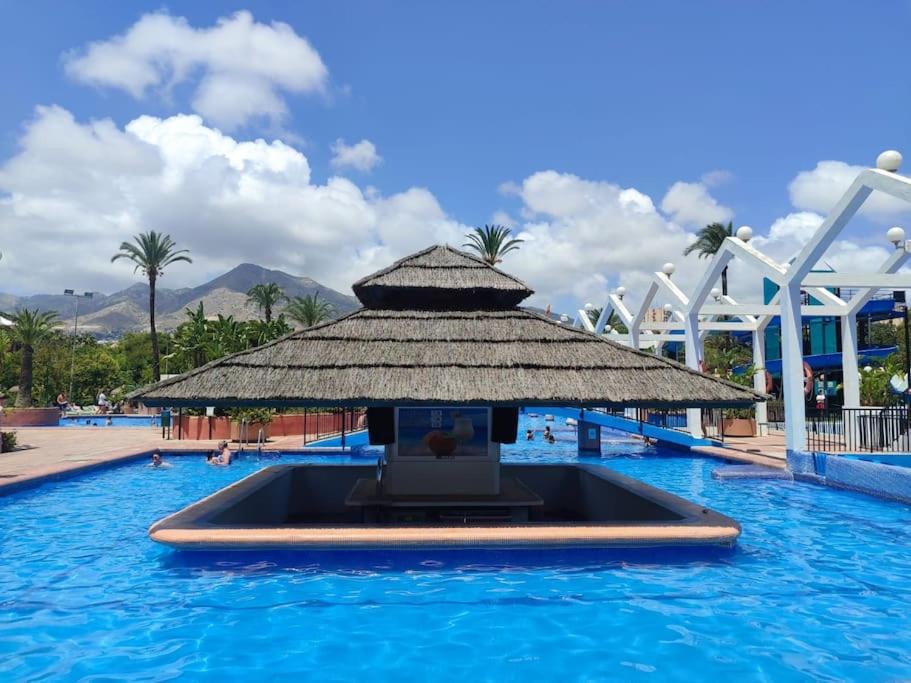 a tv in the middle of a pool at a resort at Benalbeach Paradise in Benalmádena