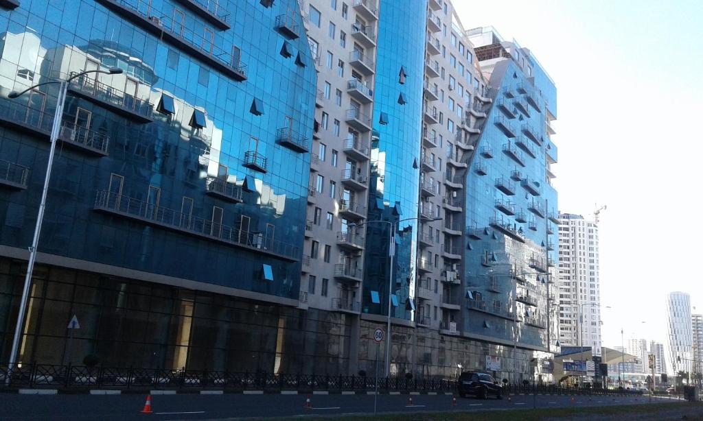 a group of tall buildings in a city at Apartment on Khimshiashvili 1 in Batumi