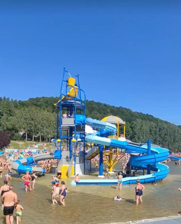 a group of people in the water at a water park at Góry Stołowe Camp - Rodzinne pole biwakowe, Kampery, Przyczepy, Namioty in Radków