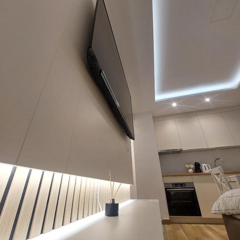 a television hanging on a wall in a kitchen at Stan na dan Borik Banja Luka in Banja Luka