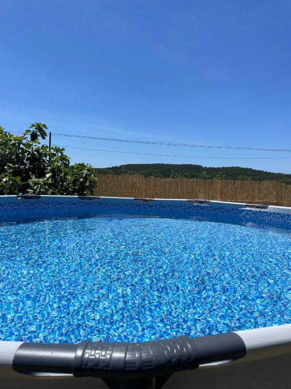 a large swimming pool with blue water at Casa da Abrunheira in Ramalhal