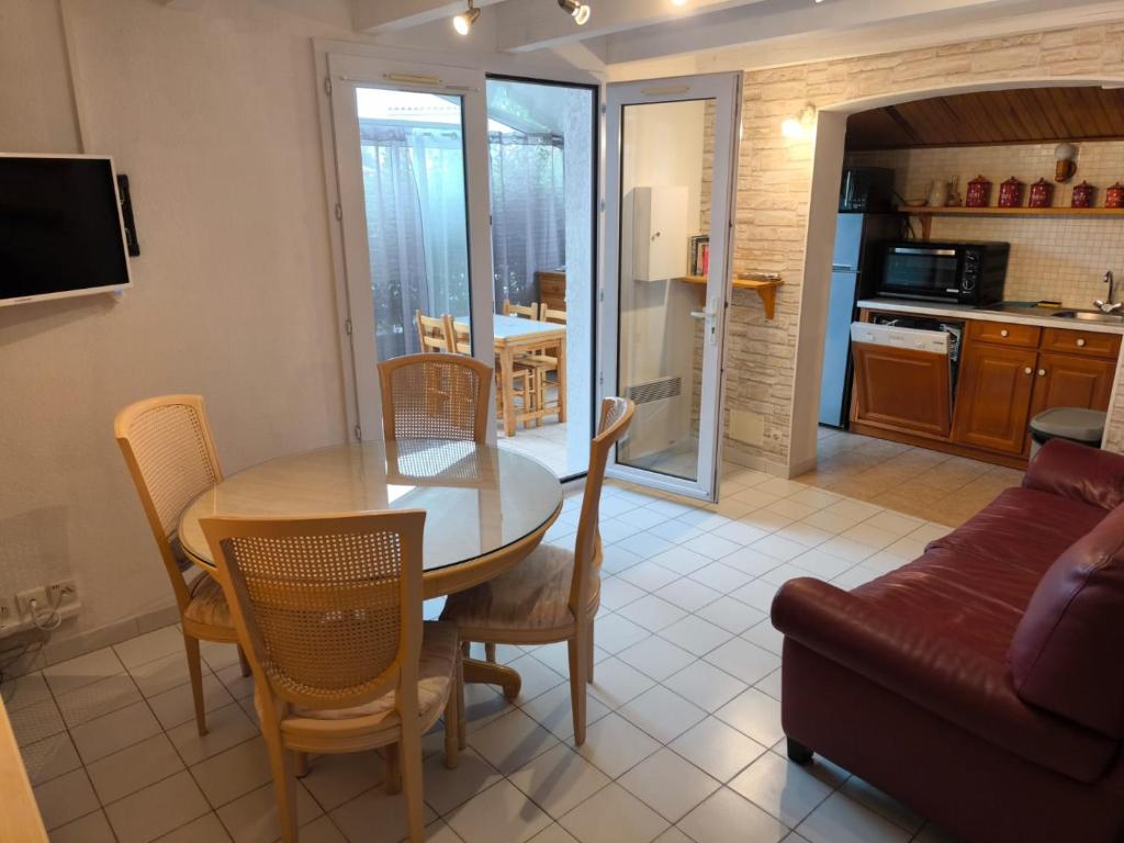 - une cuisine et une salle à manger avec une table et un canapé dans l'établissement Les VAGUES DE LA GARDIOLE, à Vic-la-Gardiole
