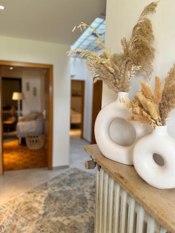 a white vase sitting on a counter in a room at Ferienhaus Zipfelstube in Selfkant