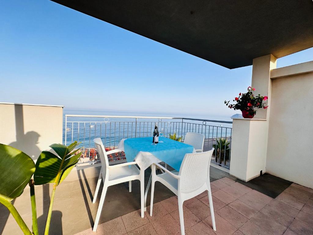 a table and chairs on a balcony with a view of the ocean at Maniel Beach Hotel in Letojanni