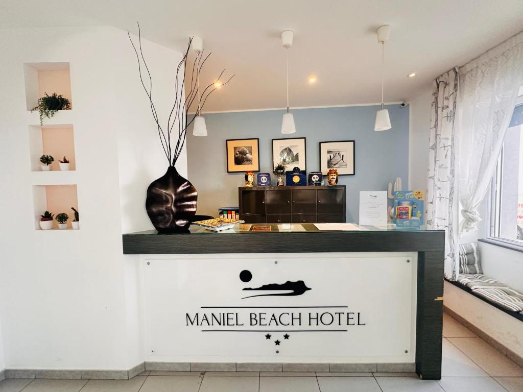 a room with a counter with a sign that reads manual beach hotel at Maniel Beach Hotel in Letojanni