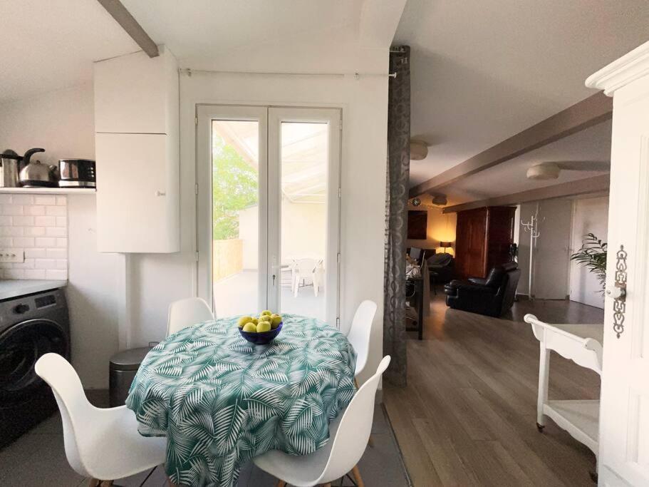 - une table avec un bol de fruits dans la cuisine dans l'établissement Appartement cozy avec terrasse, idéal pour les JO!, à Aubervilliers