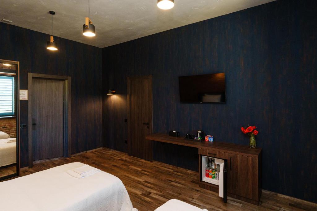 TV a/nebo společenská místnost v ubytování Palmira Hotel