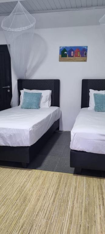 two beds in a room with two at Rumah Casablanca in Montongbuwoh