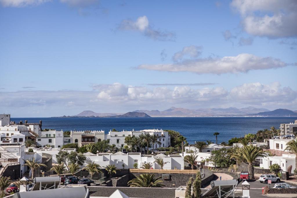 a view of a city and the ocean at Caybeach Papagayos in Playa Blanca