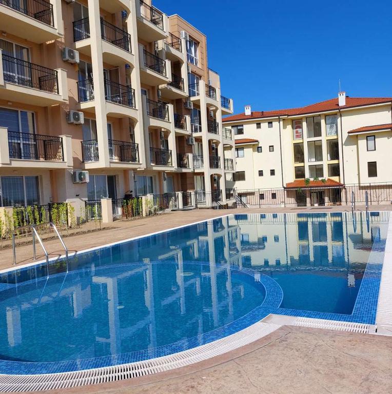 a swimming pool in front of a apartment building at Sun Holidays Byala in Byala