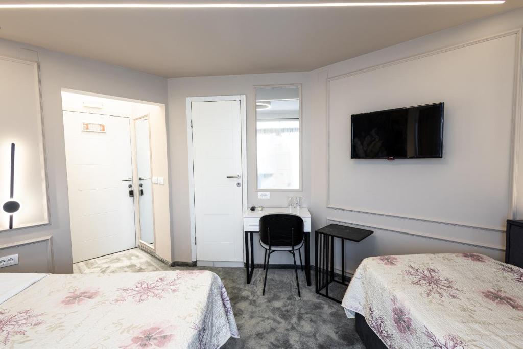 Postel nebo postele na pokoji v ubytování Garni Hotel Lotos