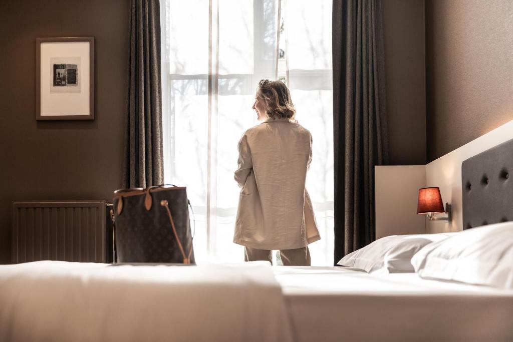 Postel nebo postele na pokoji v ubytování Hotel Navarra Brugge