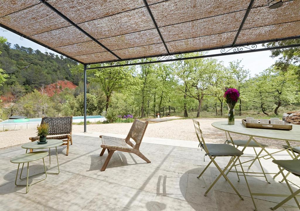 eine Terrasse mit Stühlen und einem Tisch mit einem Picknicktisch in der Unterkunft Villa Cinsault, un bijou pour votre séjour en Provence Verte in La Celle