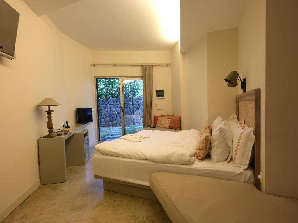 Postel nebo postele na pokoji v ubytování Bella Sombra Hotel