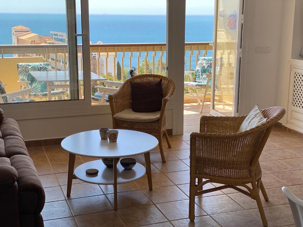 a living room with a couch and chairs and a table at Apartamento El Palmeral Aguadulce in Aguadulce