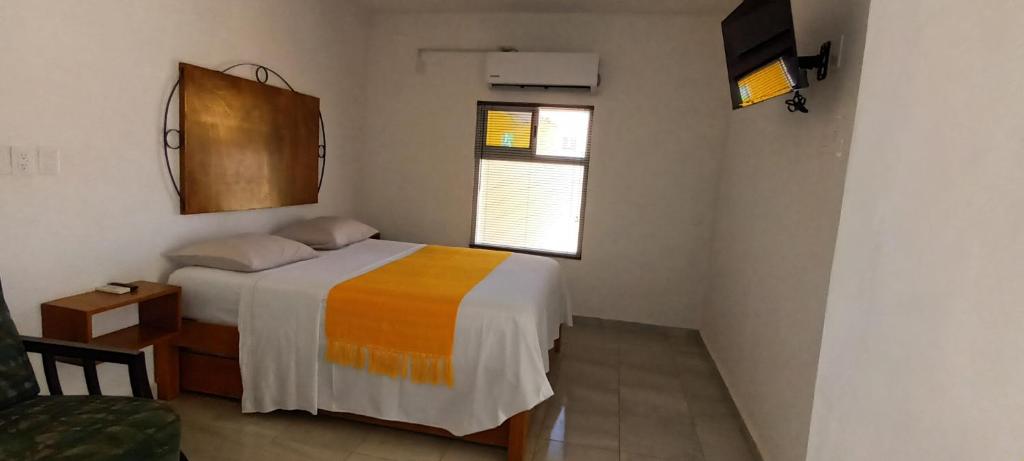 Postel nebo postele na pokoji v ubytování Buenosdías Izamal