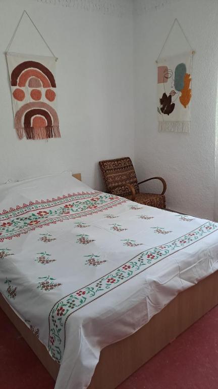 a bedroom with a large bed with a blanket on it at Casa antonyo in Jurilovca